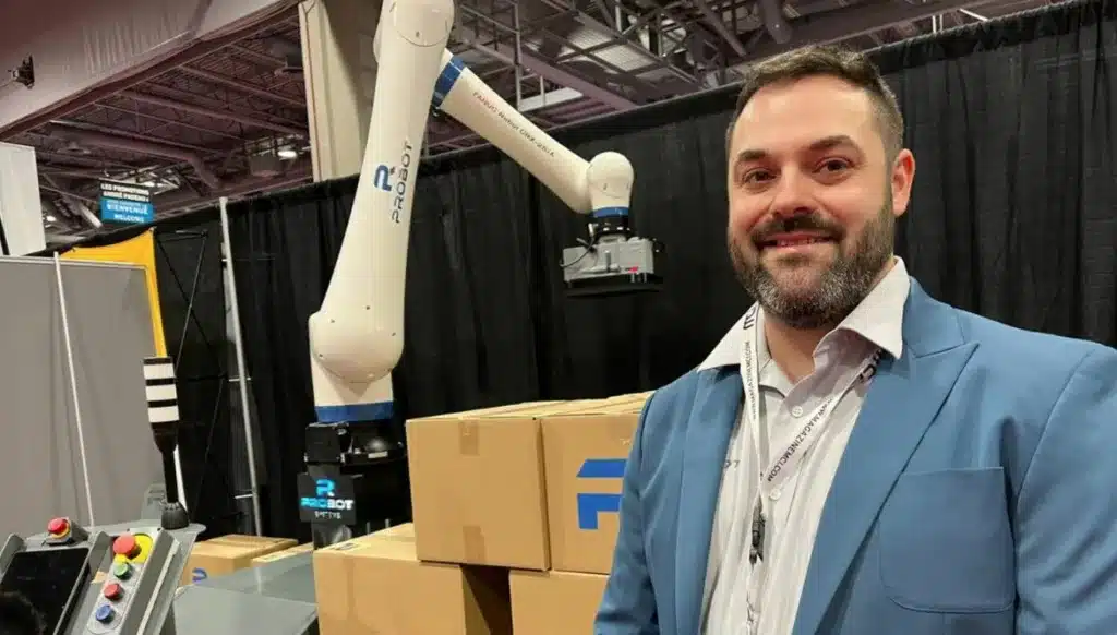 Probot’s president in front of the Probot robotic palletizer